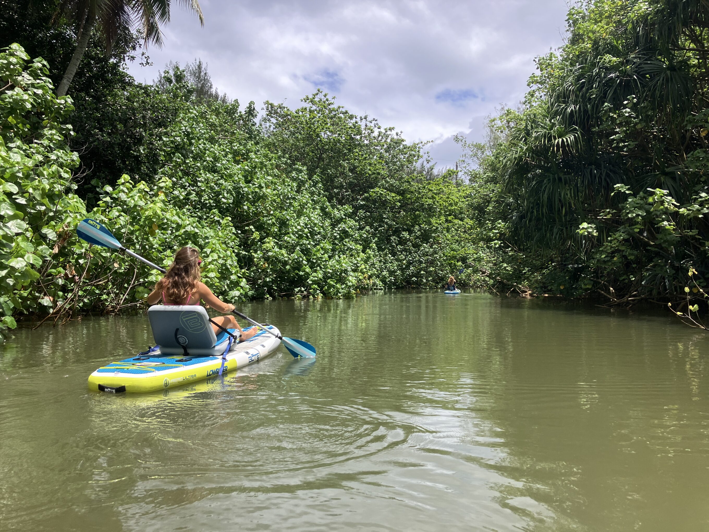 a woman kayaking in a lagoon