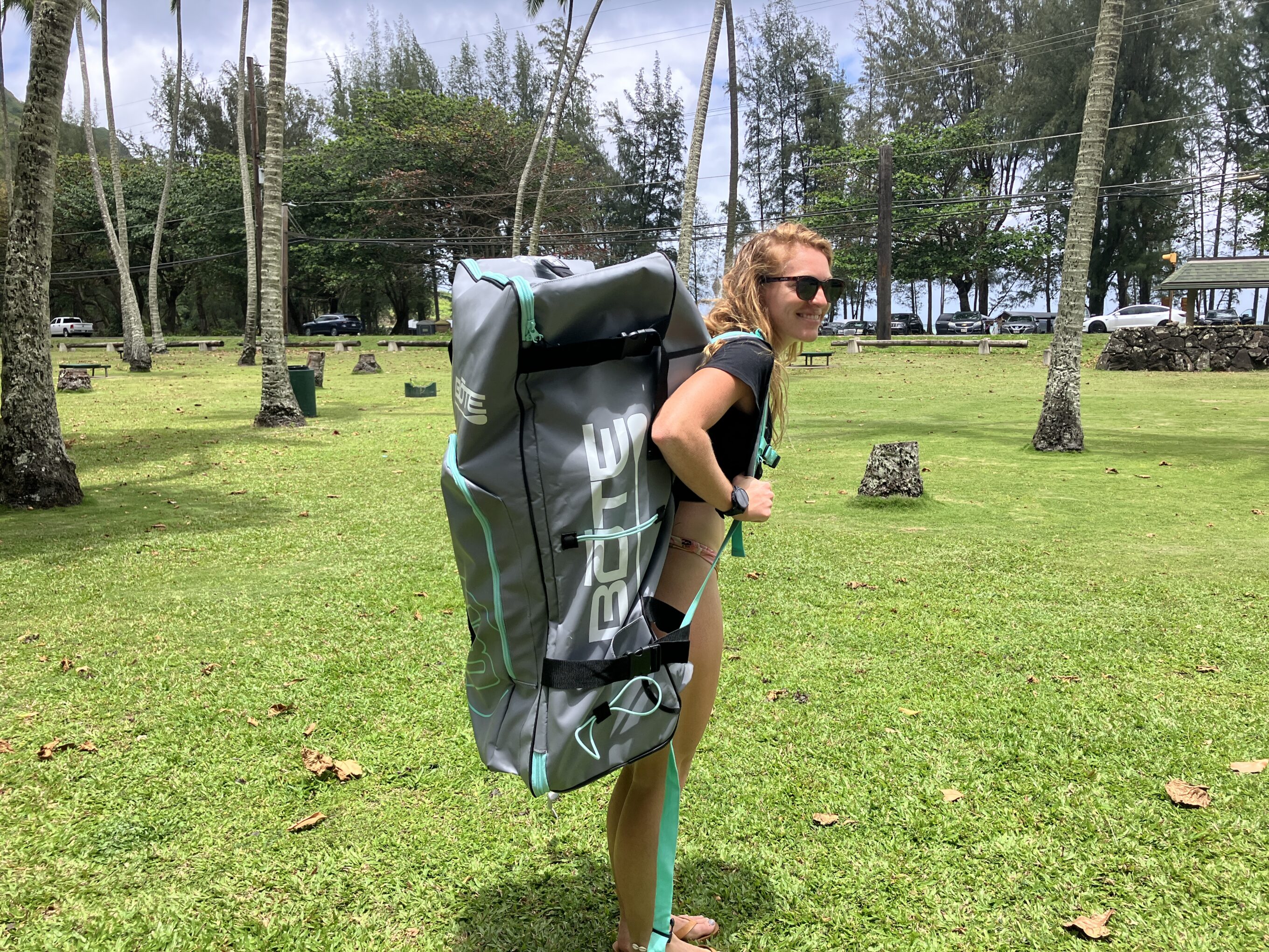 a woman carrying a BOTE stand up paddle backpack