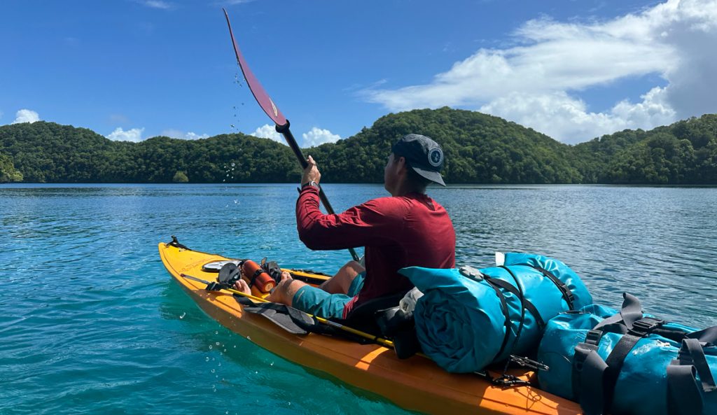 man kayaking in a sun shirt