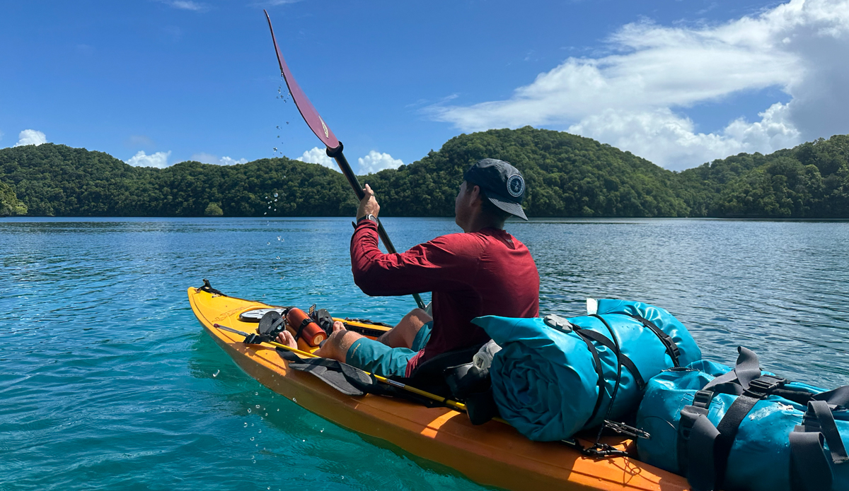 man kayaking in a sun shirt