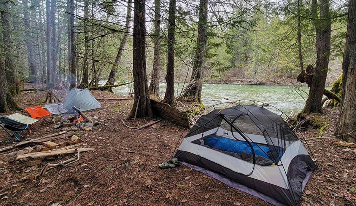 two backpacking tents next to a river