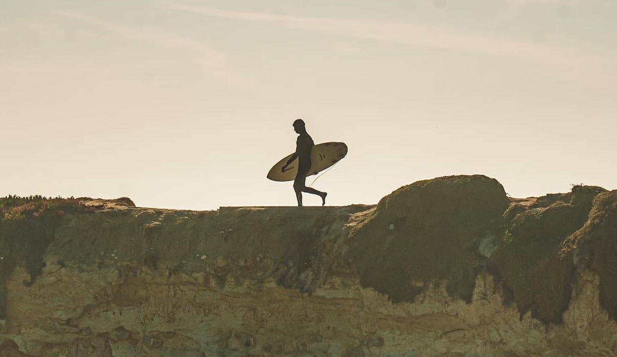 Man Walking with Surfboard on Cliff Steamer Lane