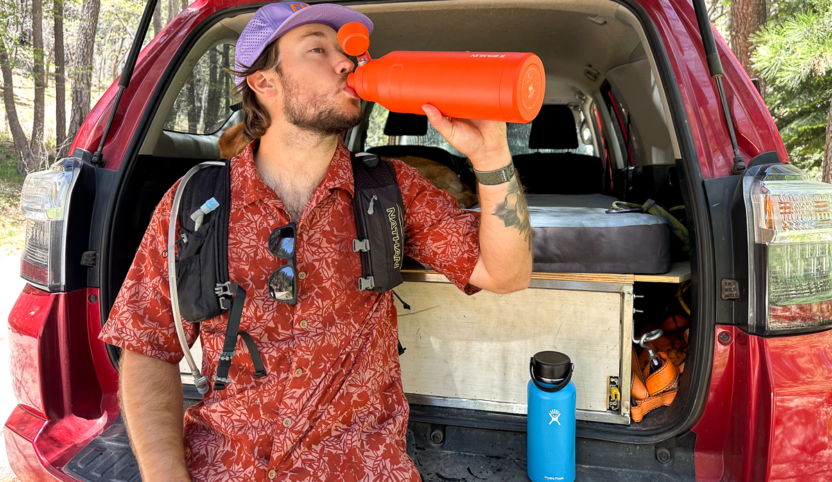 man drinking out of water bottle