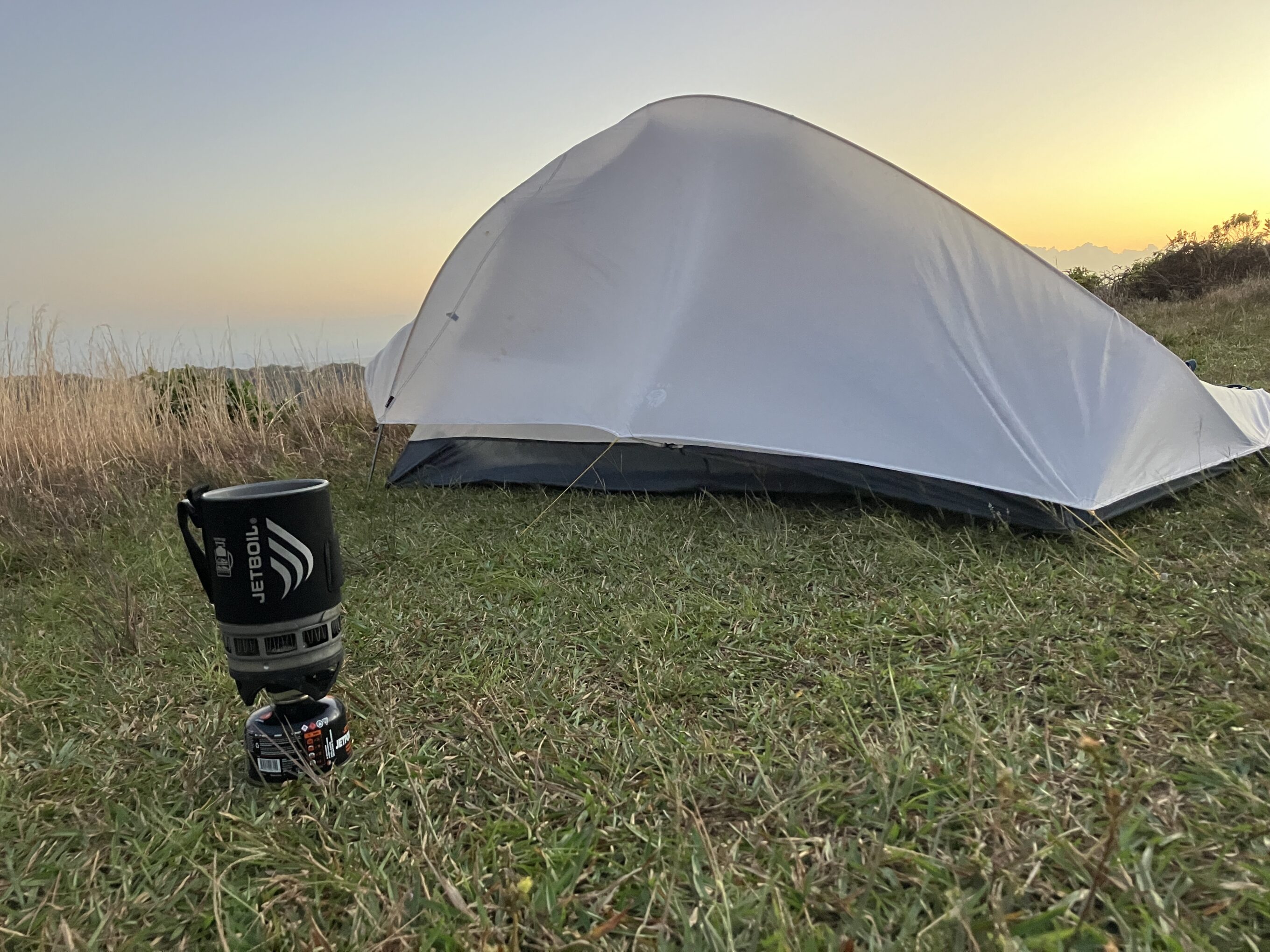 a jetboil zip in front of a backpacking tent