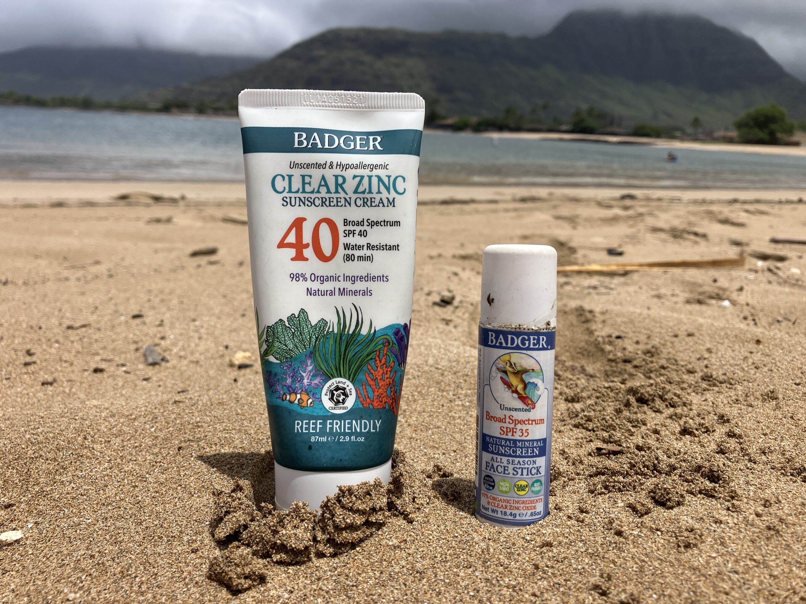 Badger sunscreen sitting on the sand