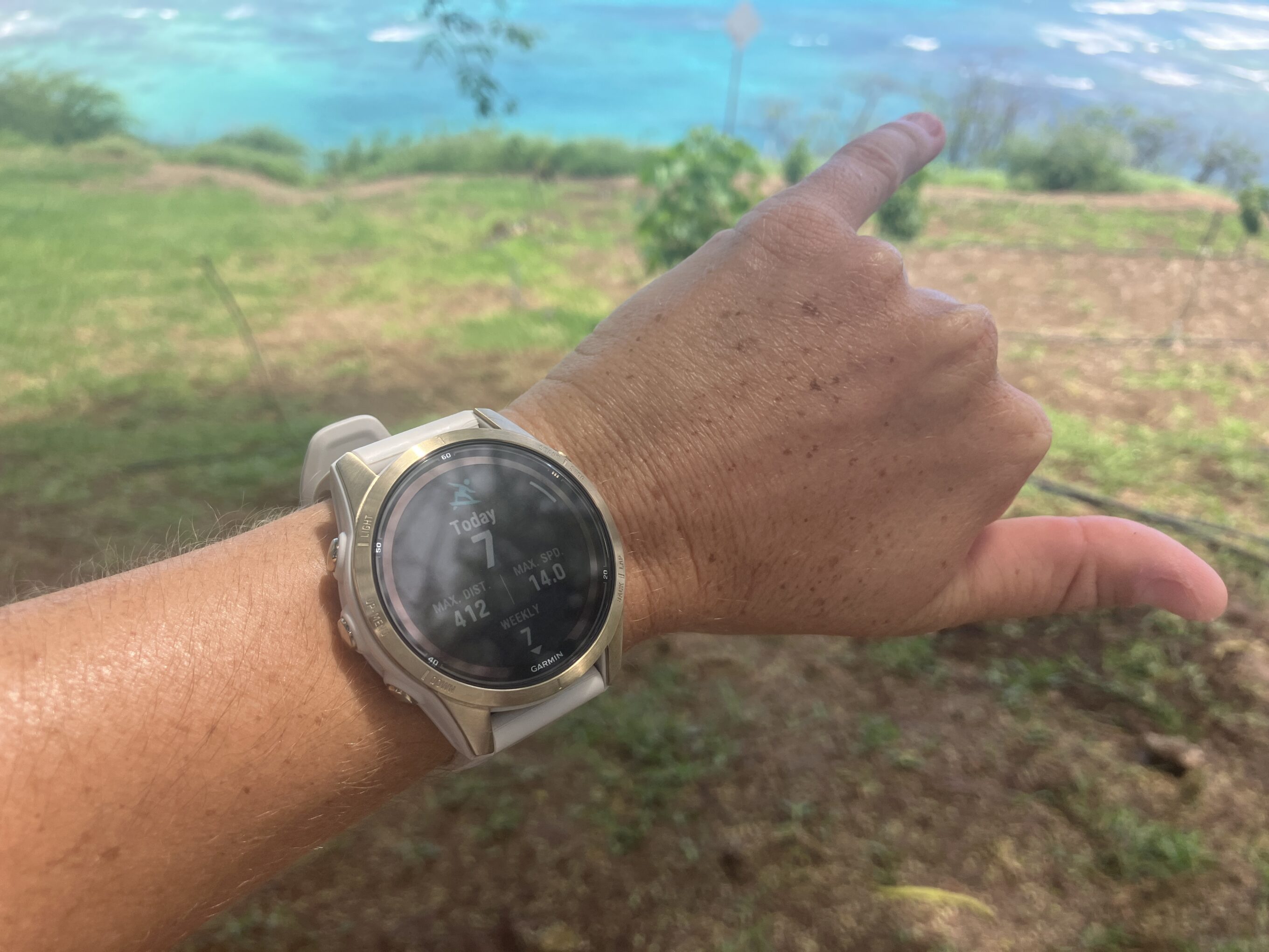 a shaka at the beach wearing a surf watch