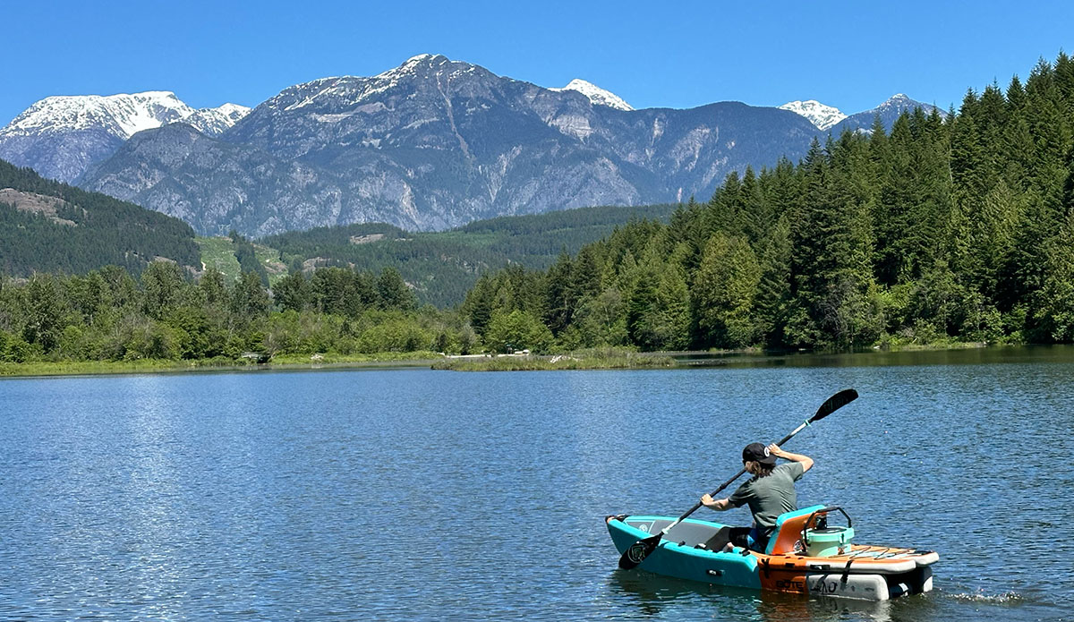 the bote aero lono kayak on a lake with a beautiful mountain backdrop