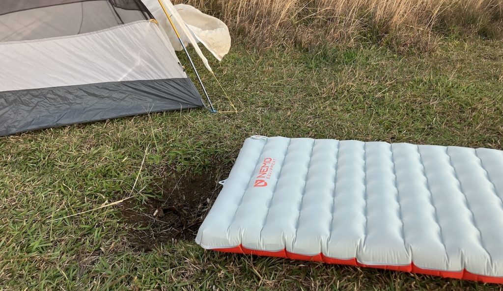 nemo tensor sleeping pad on the ground in front of a tent