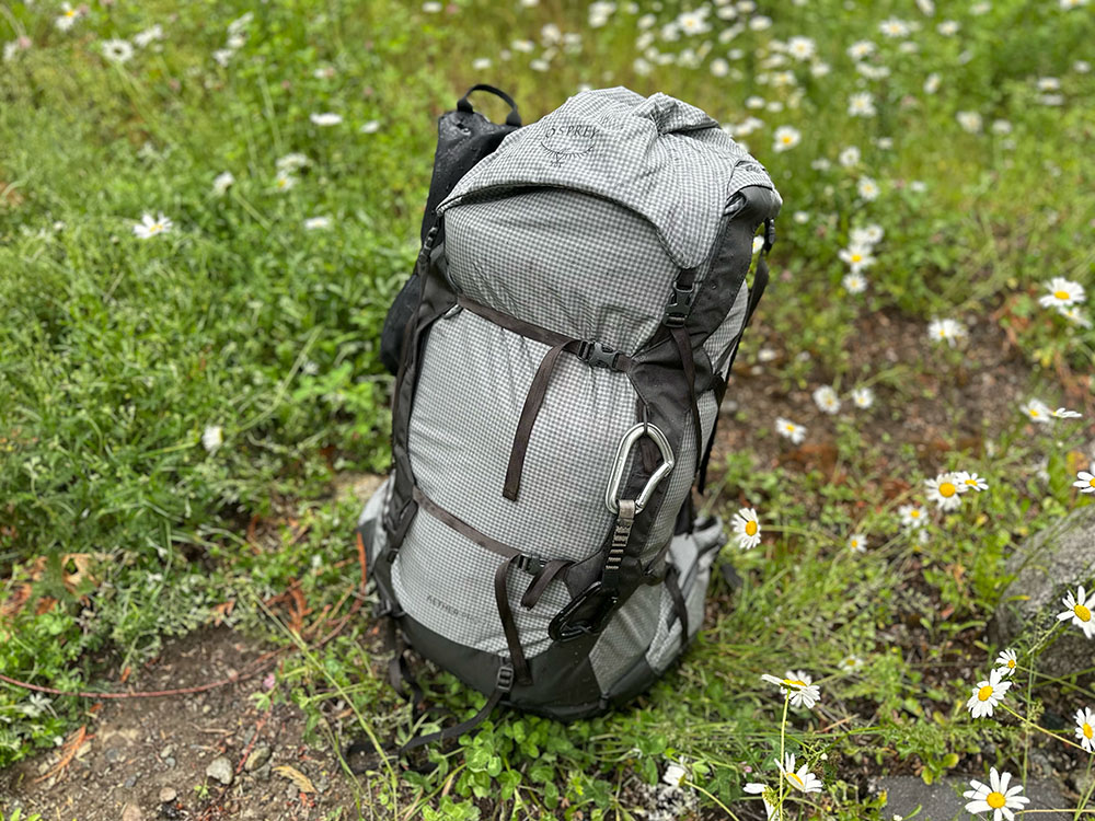 the osprey aether pro backpack sitting on the ground