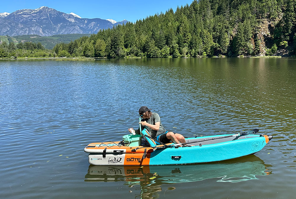 pulling a can from the cooler on the bote aero lono kayak