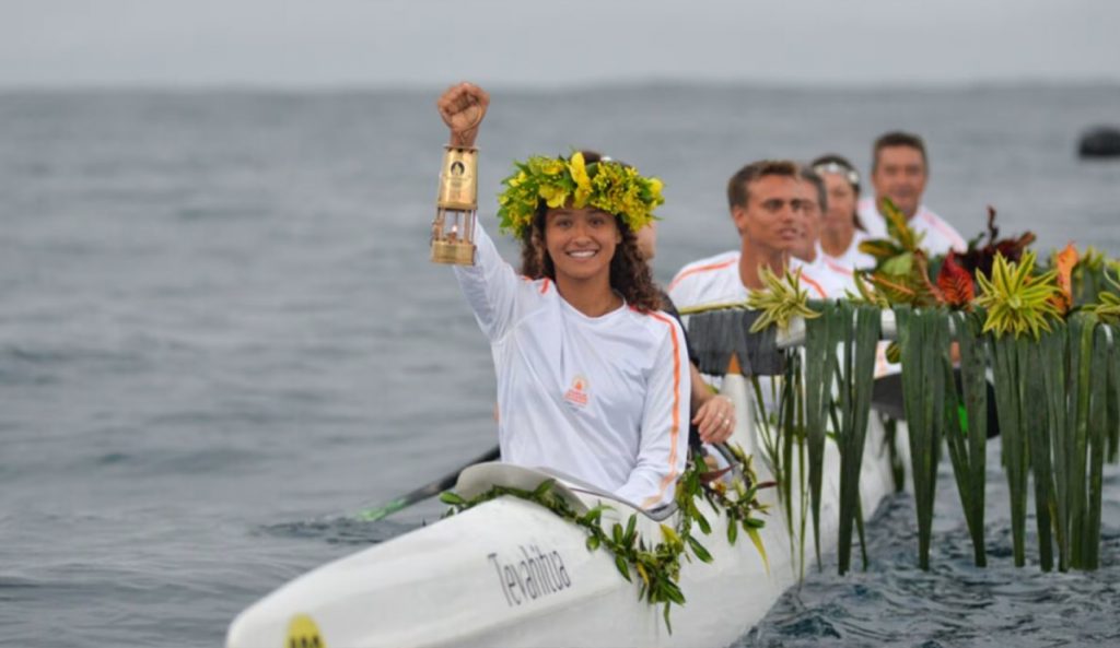 Tahitian surfer Vahine Fierro carrying the Olympic torch. Photo: Olympics.com