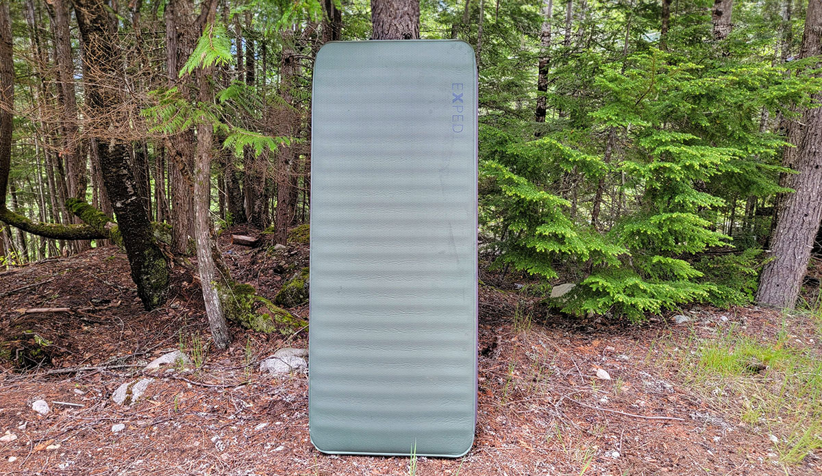 a picture of the exped megamat 10 next to a tree in the forest