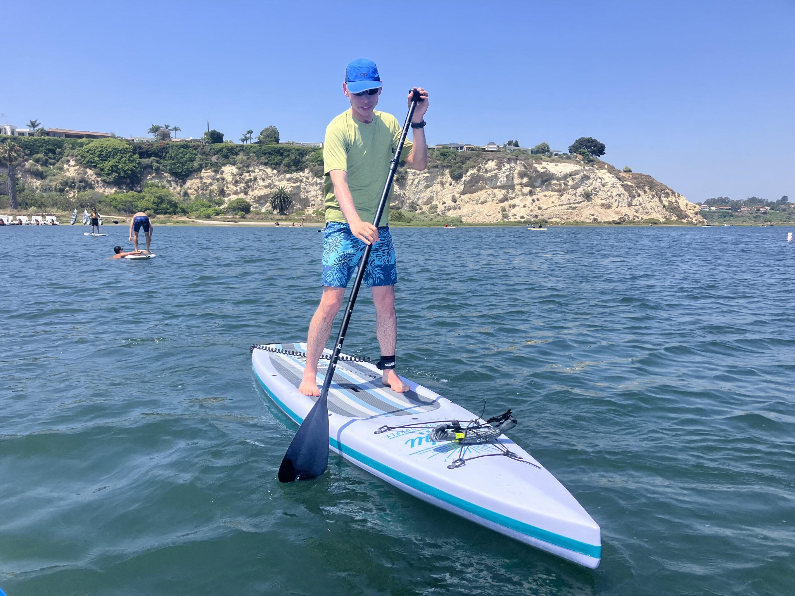 a man stand up paddling 