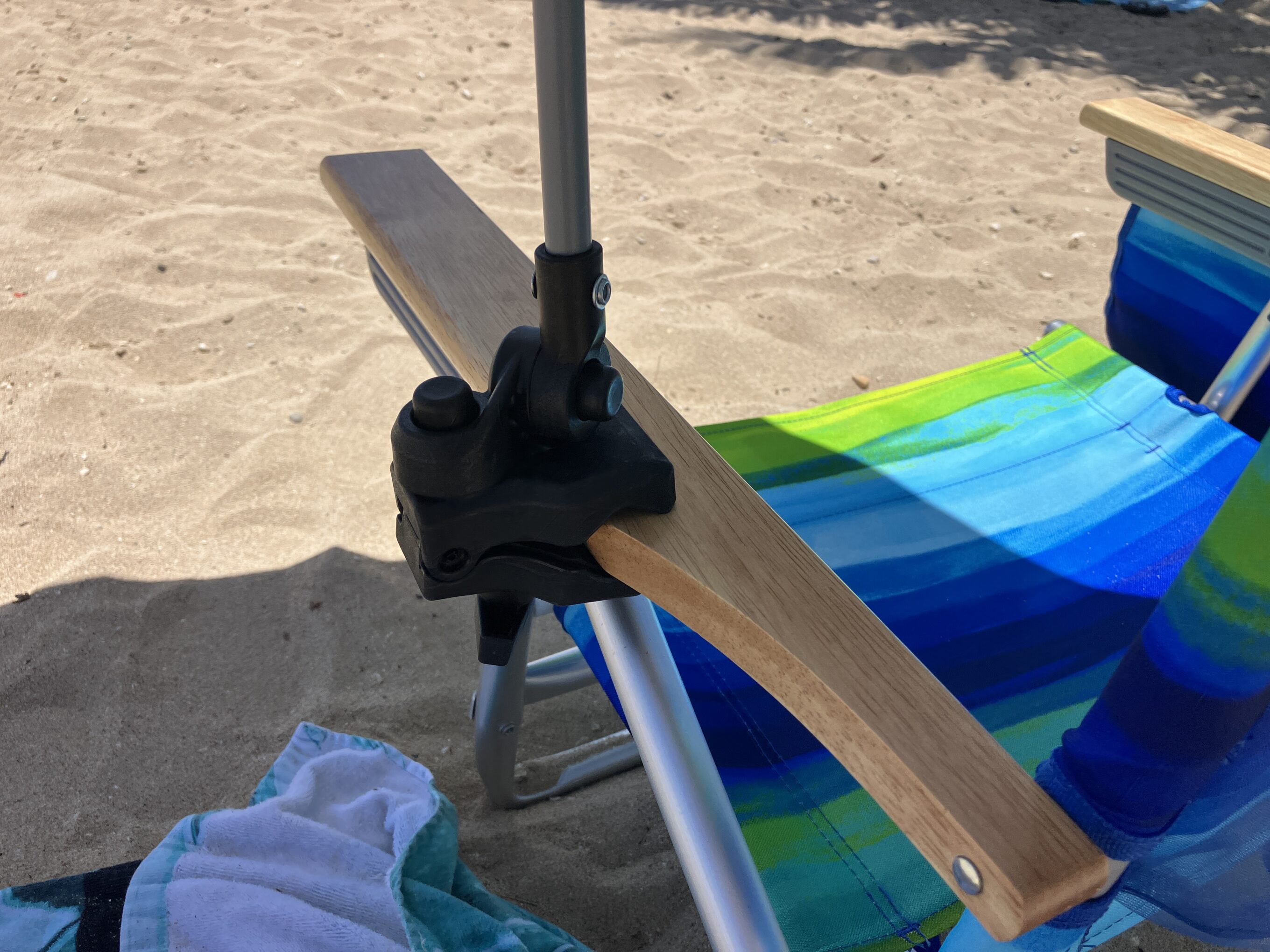 a beach umbrella hooked onto a chair