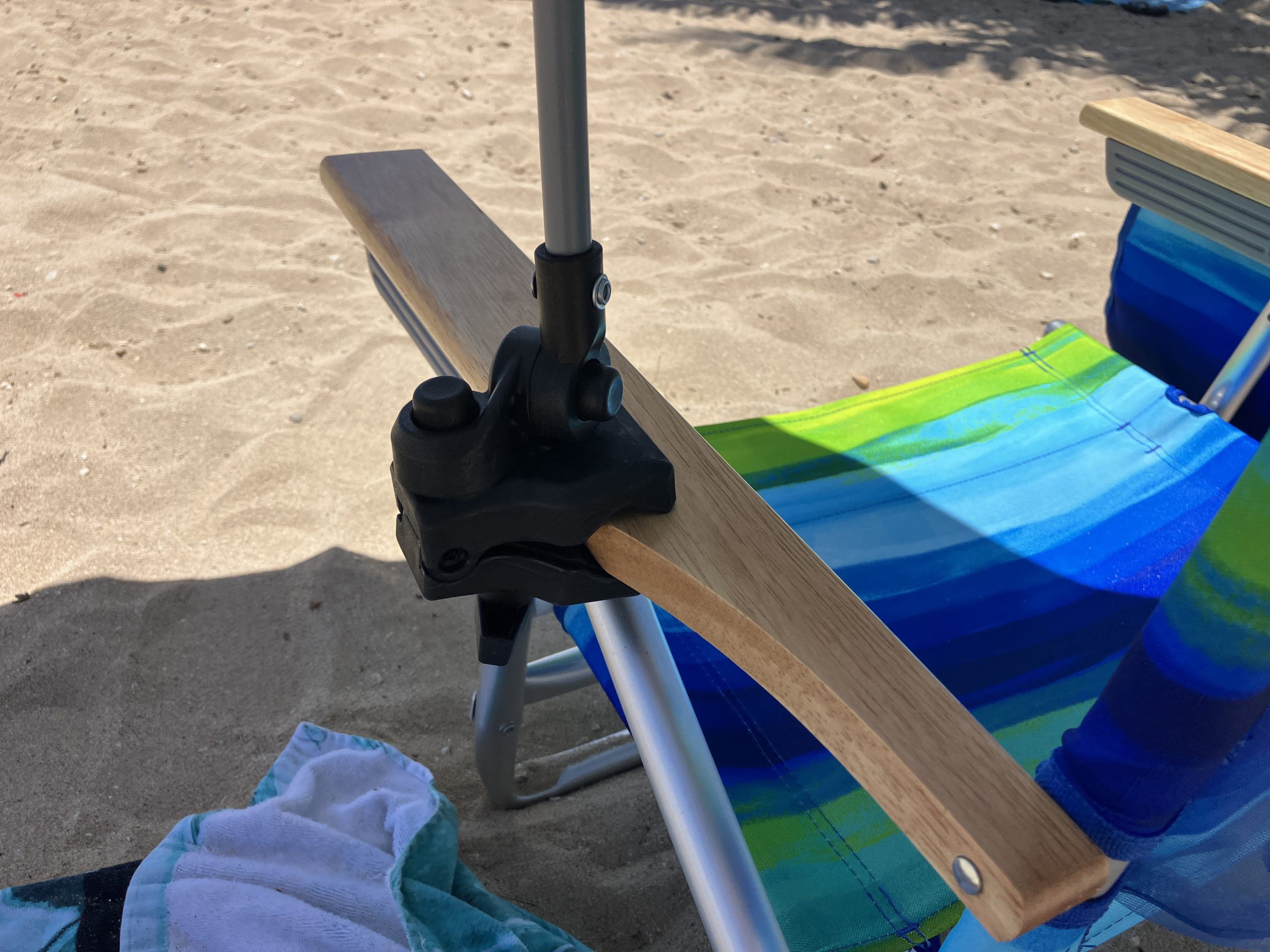 a beach umbrella hooked onto a chair