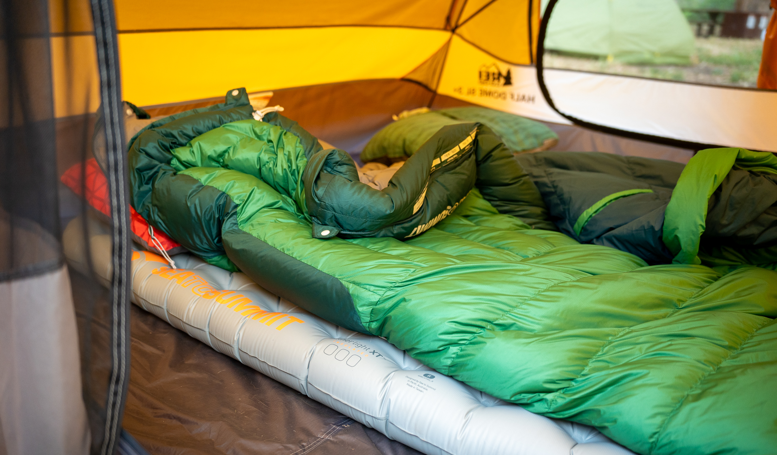 a backpacking sleeping bag and sleeping pad in a tent