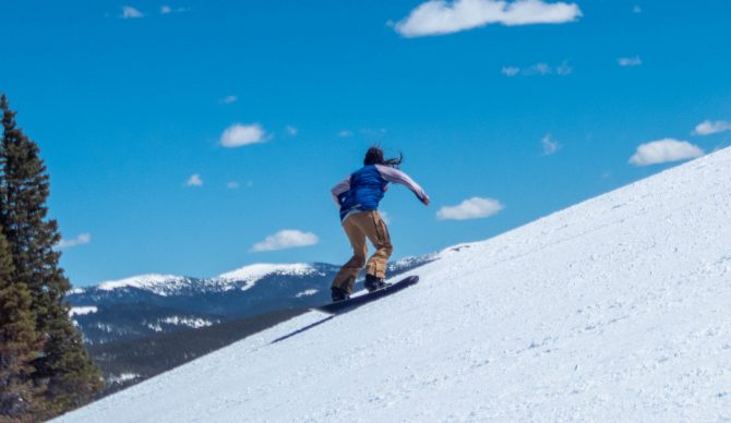 Heather Snowboarding on a ridgeline