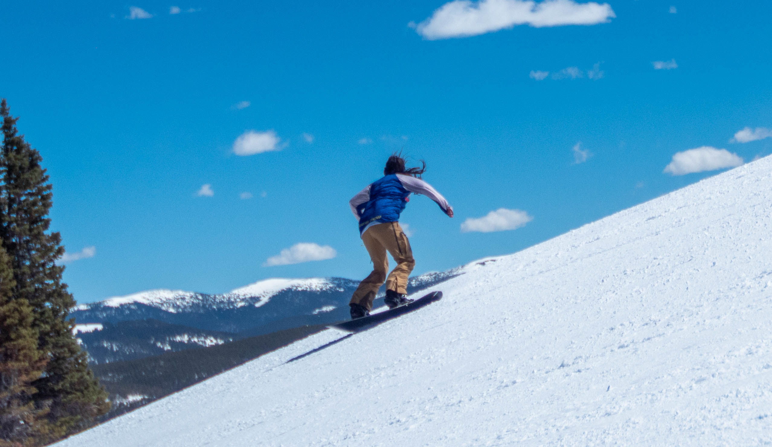 Heather Snowboarding on a ridgeline