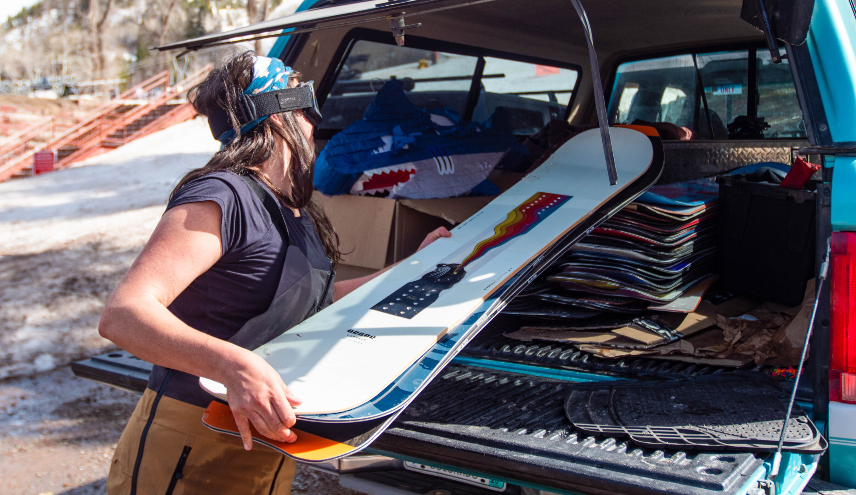 Loading women's snowboards into the back of a truck