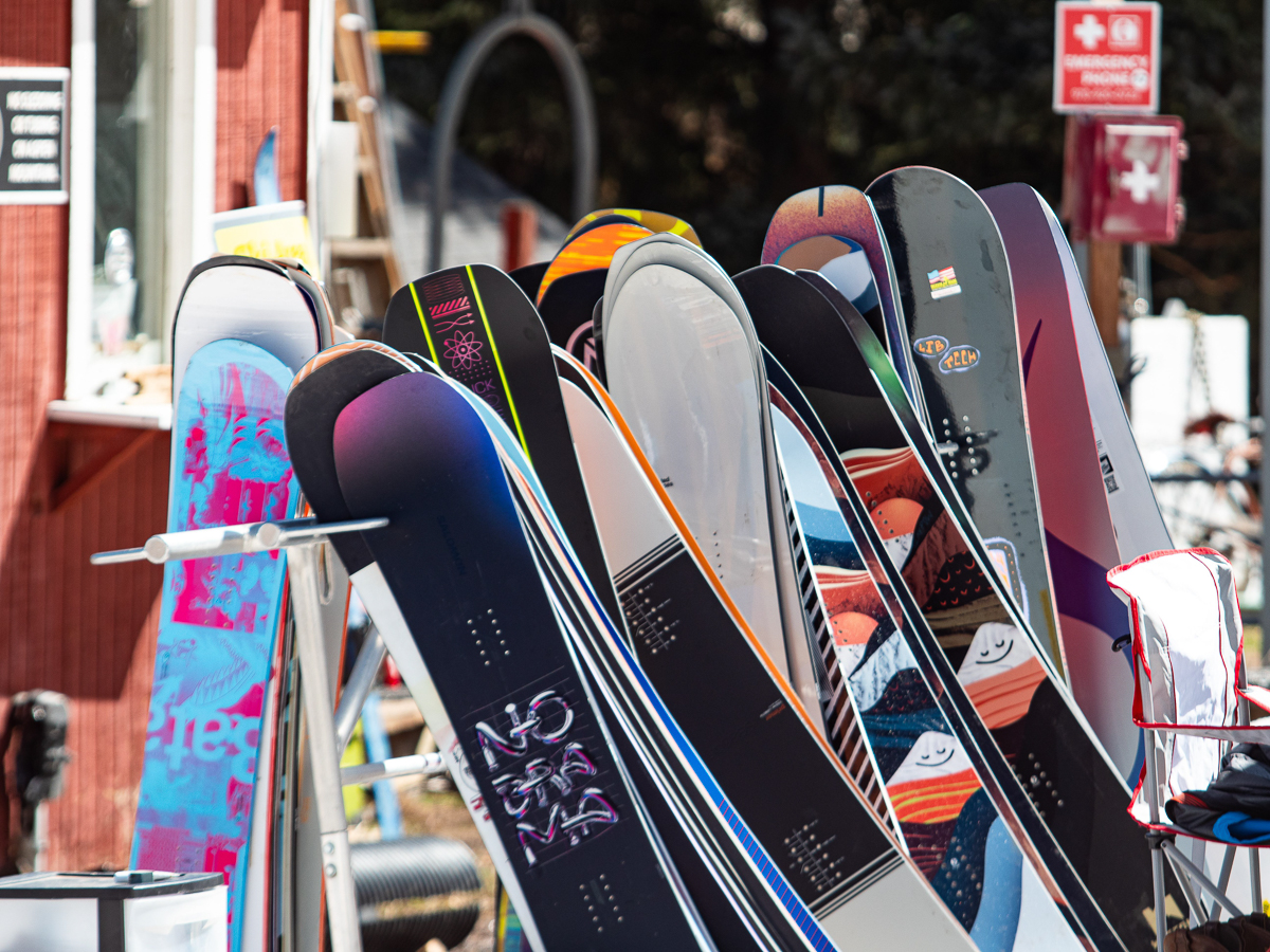 a bunch of snowboards in a rack