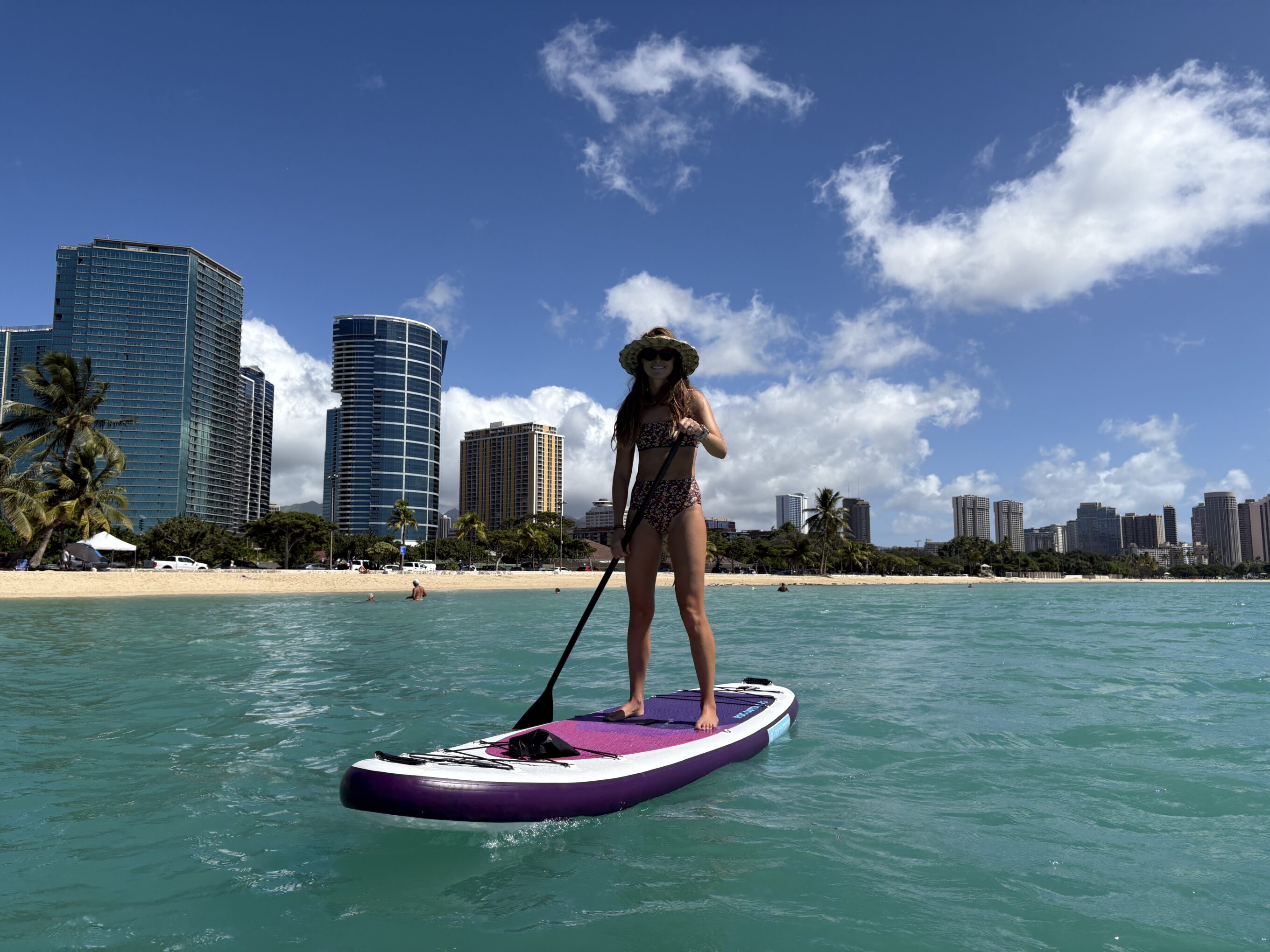 a woman stand up paddling