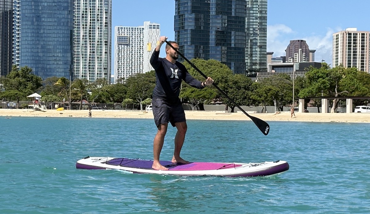 a man paddling an inflatable paddle board