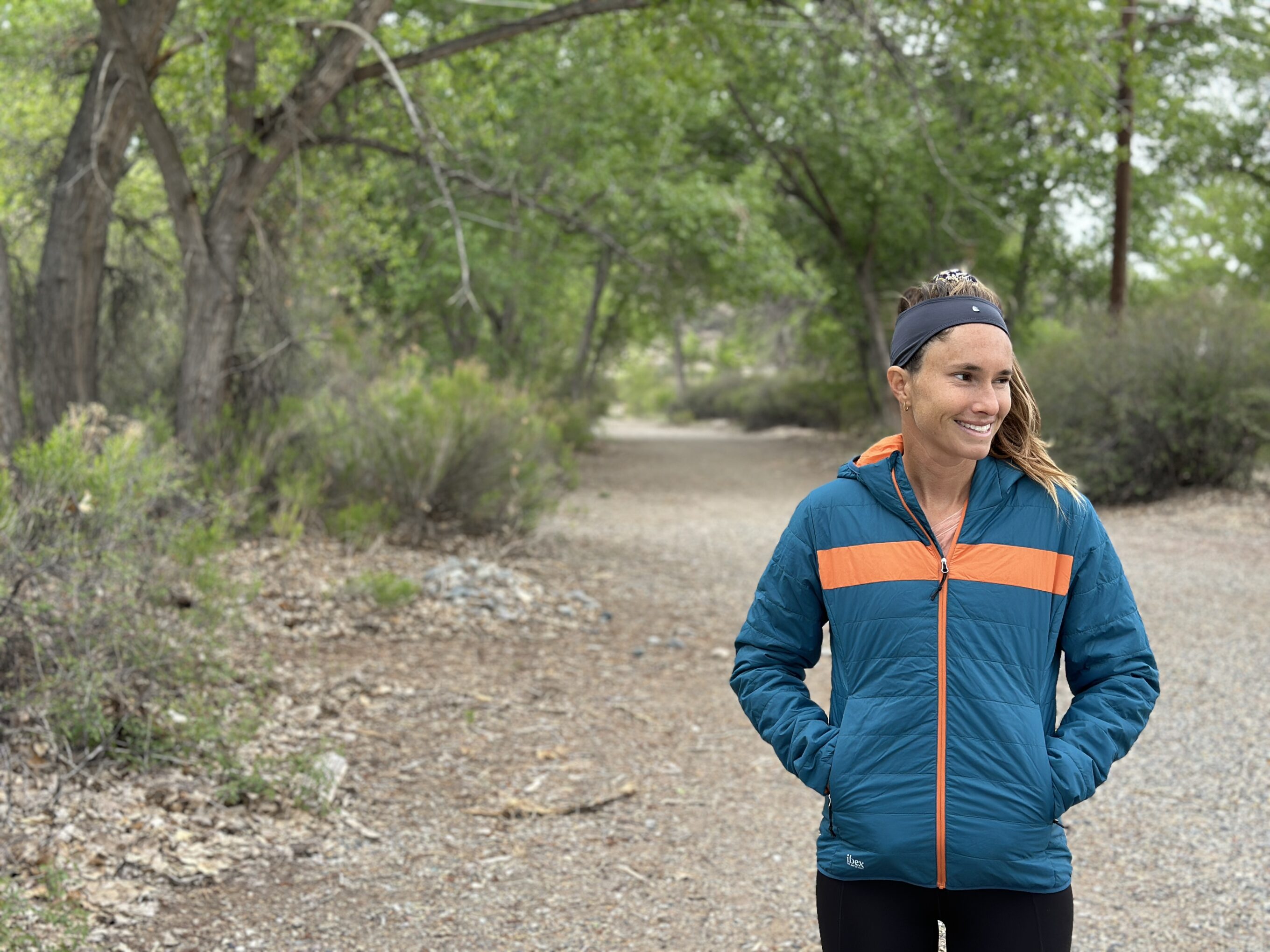 a woman in the forest in a puffer jacket