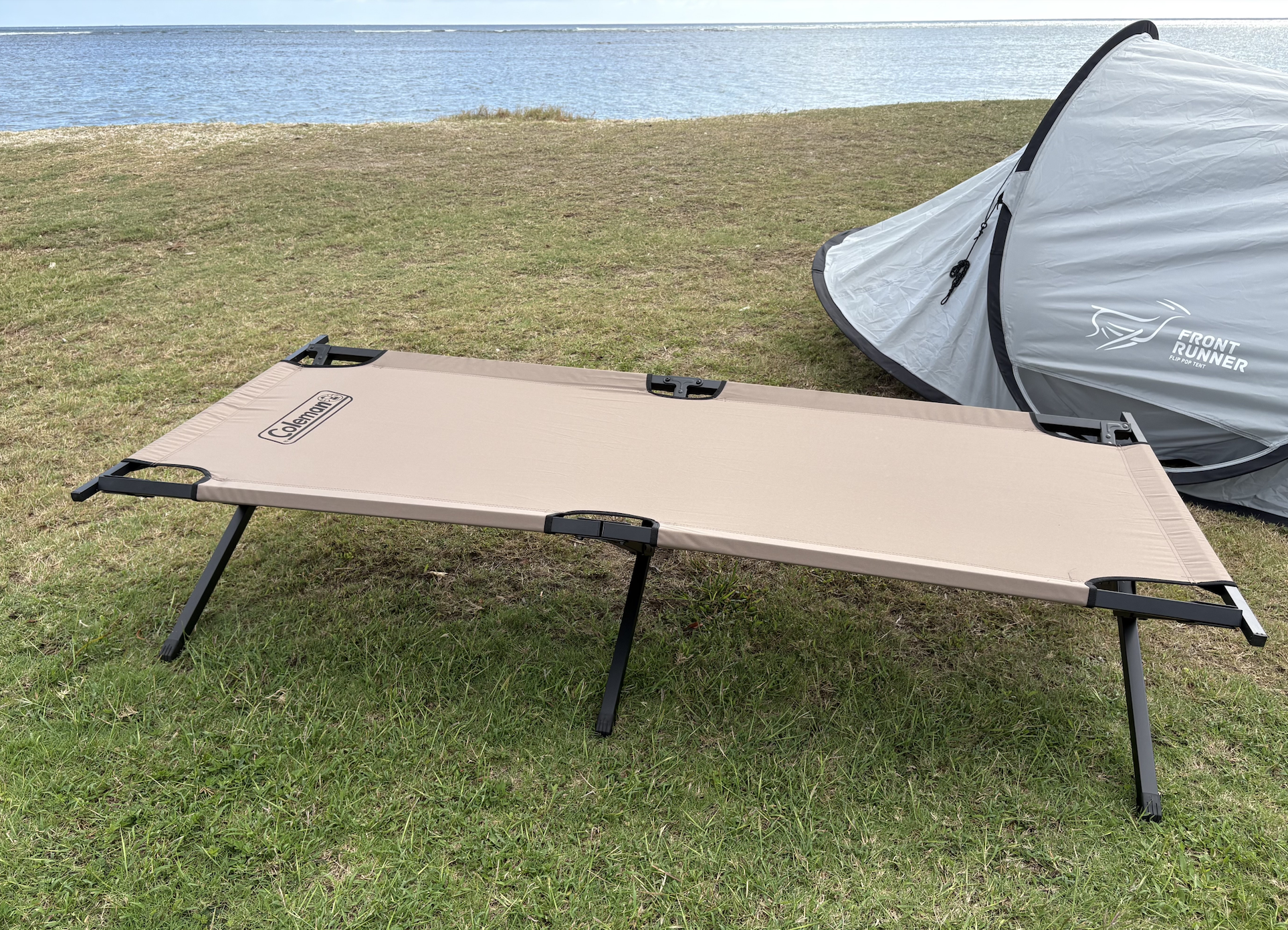 a camping cot in front of a tent