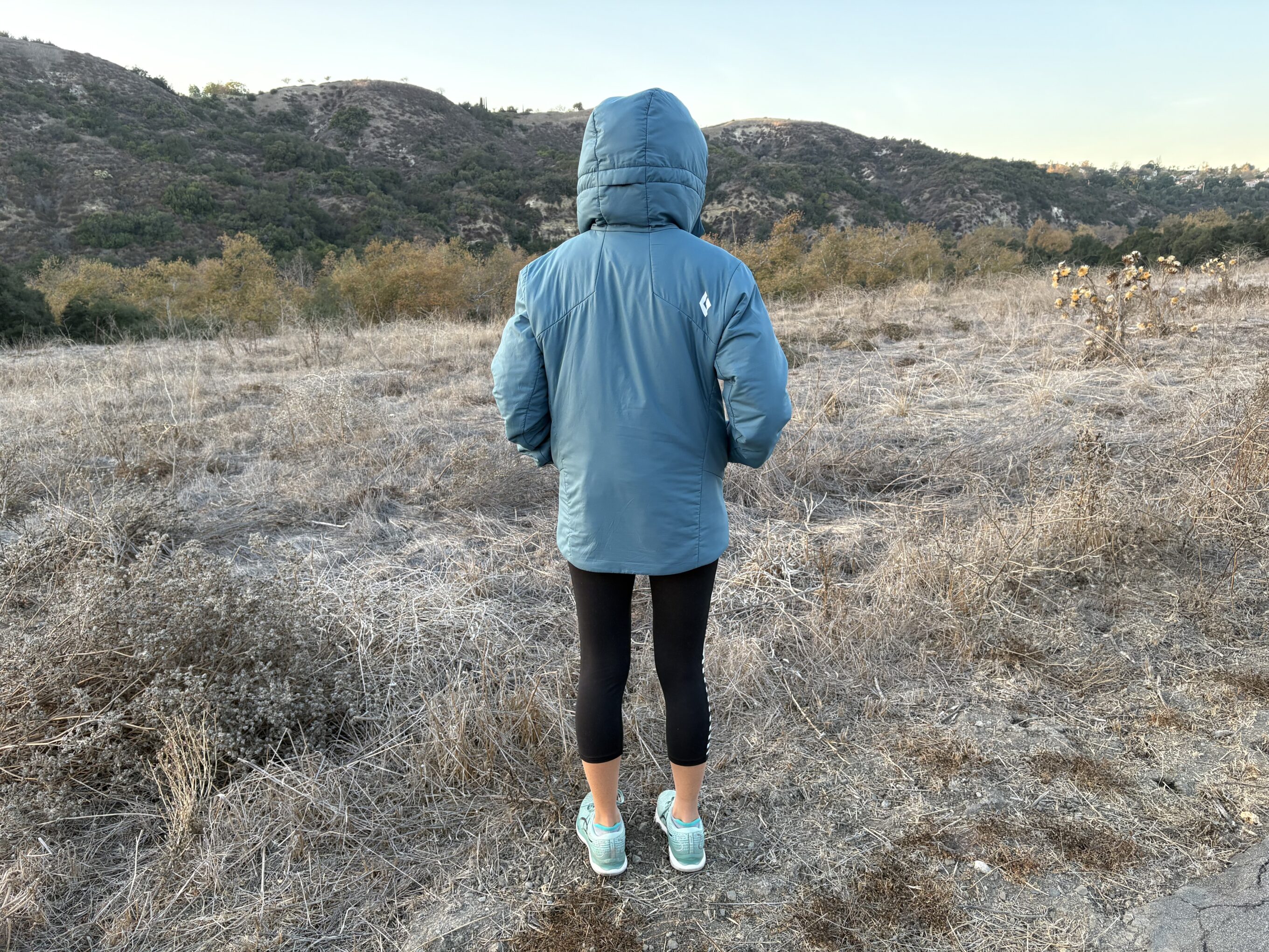 the backside of a puffer jacket on a woman