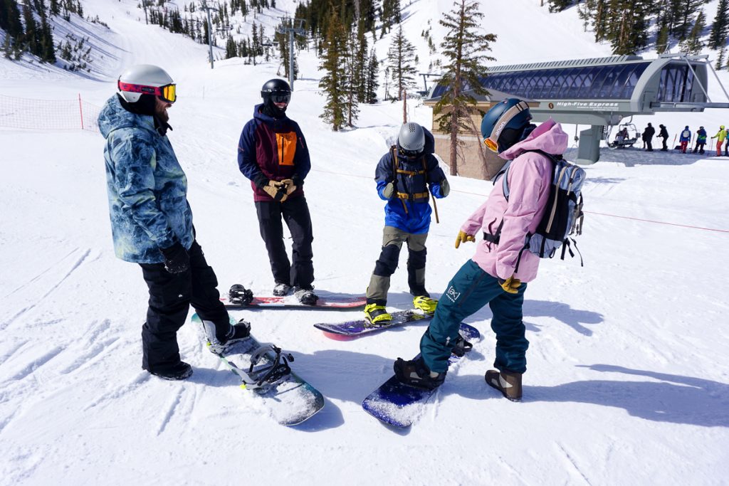 snowboarders standing around 