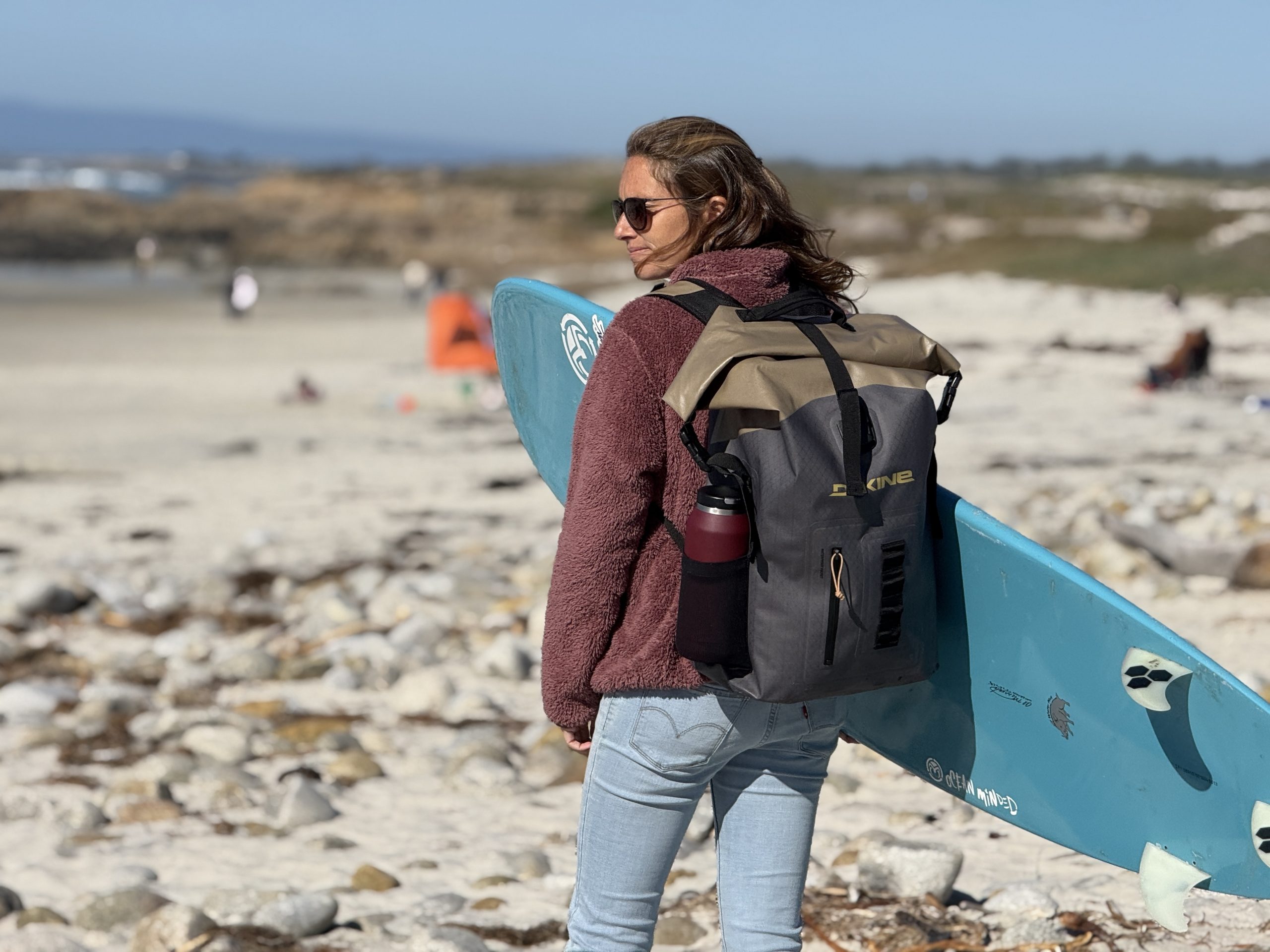 a woman wearing a dakine cyclone backpack