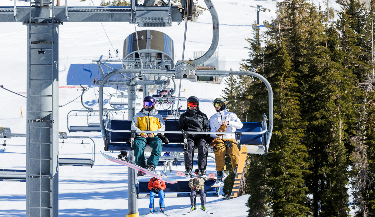 three people on a ski chair lift