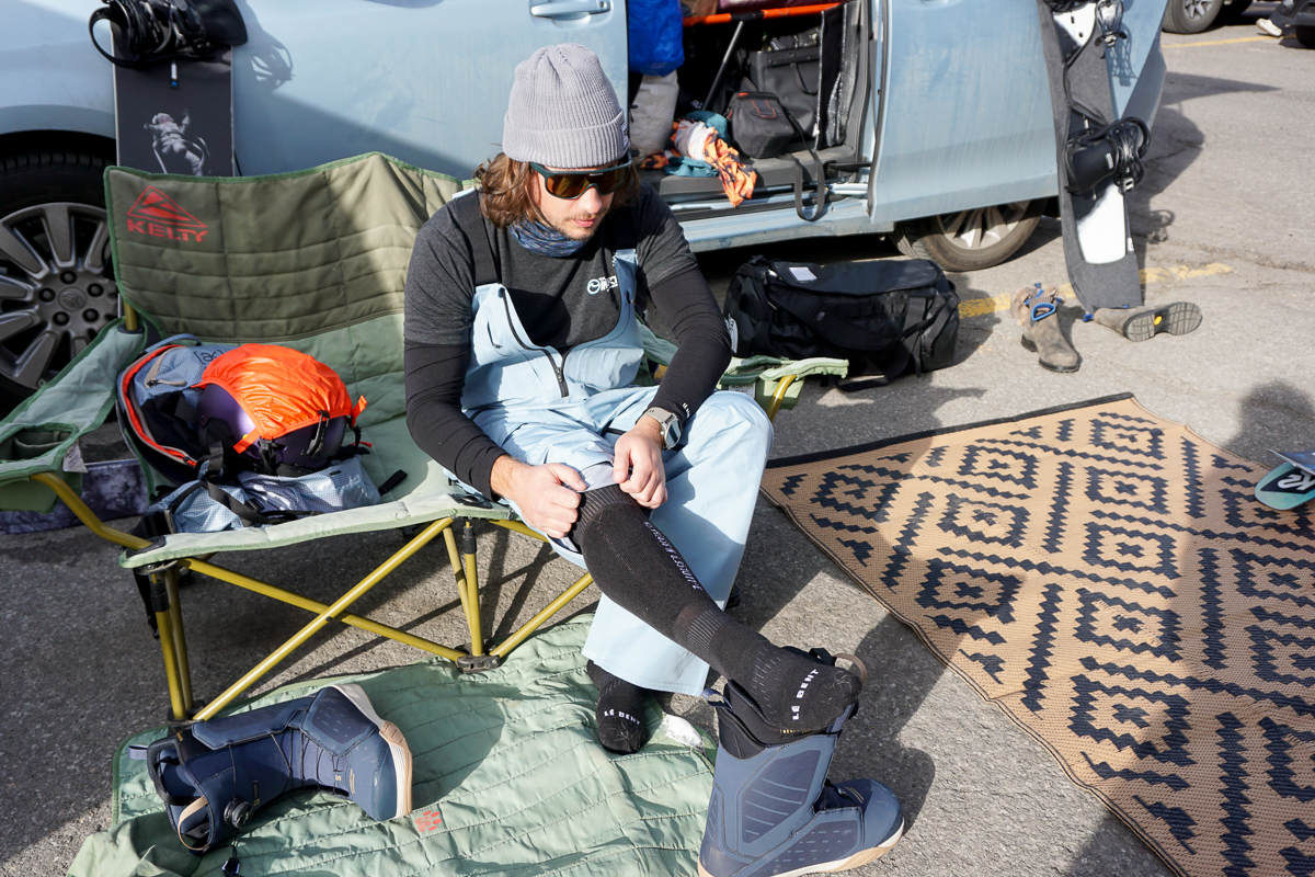 man putting on snowboard socks