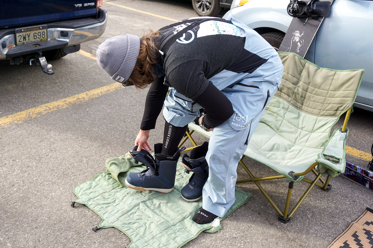 man putting on snowboard boots