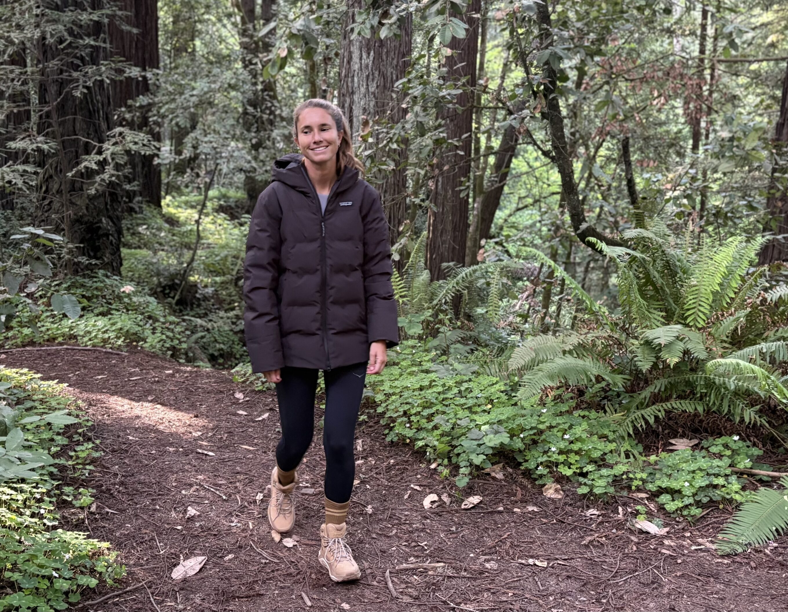 a woman walking in the forest in hiking boots