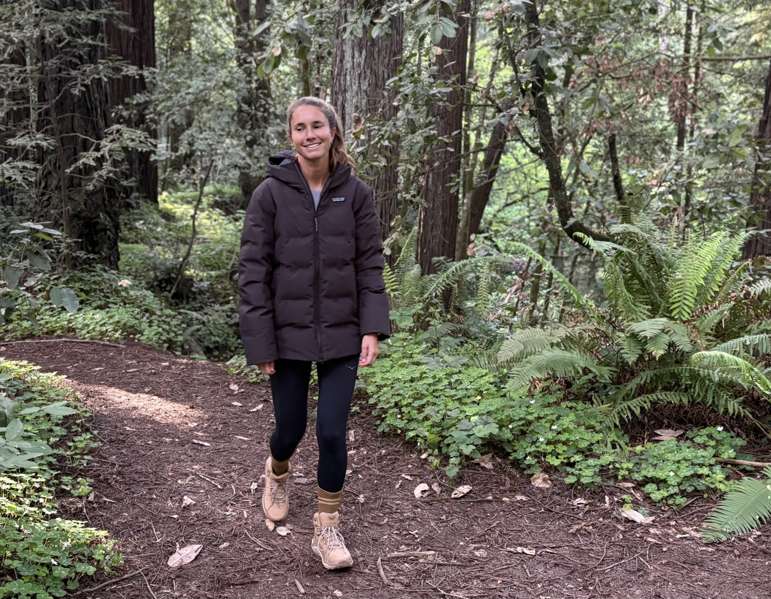 a woman walking in the forest in hiking boots