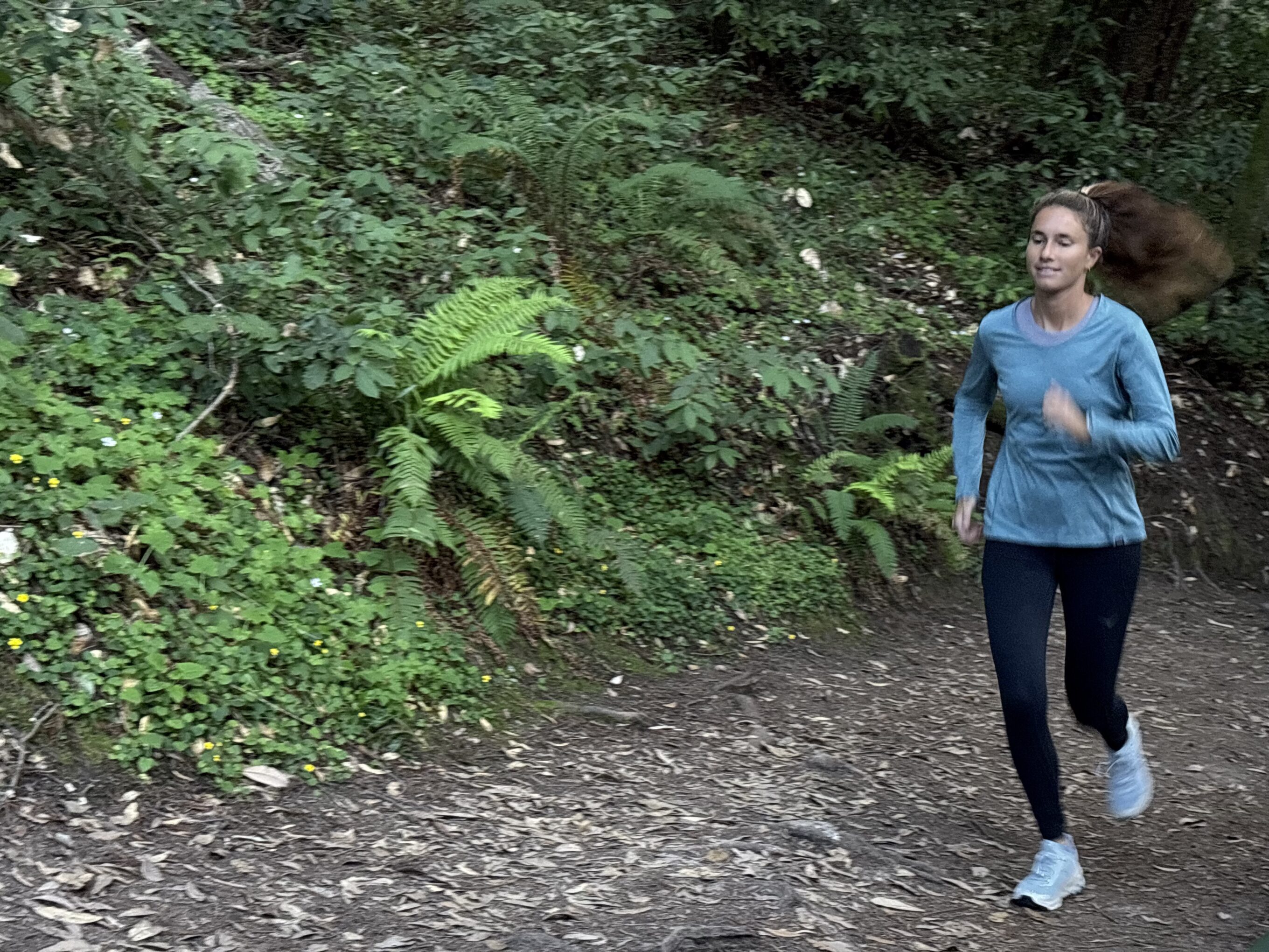 a woman running in the forest