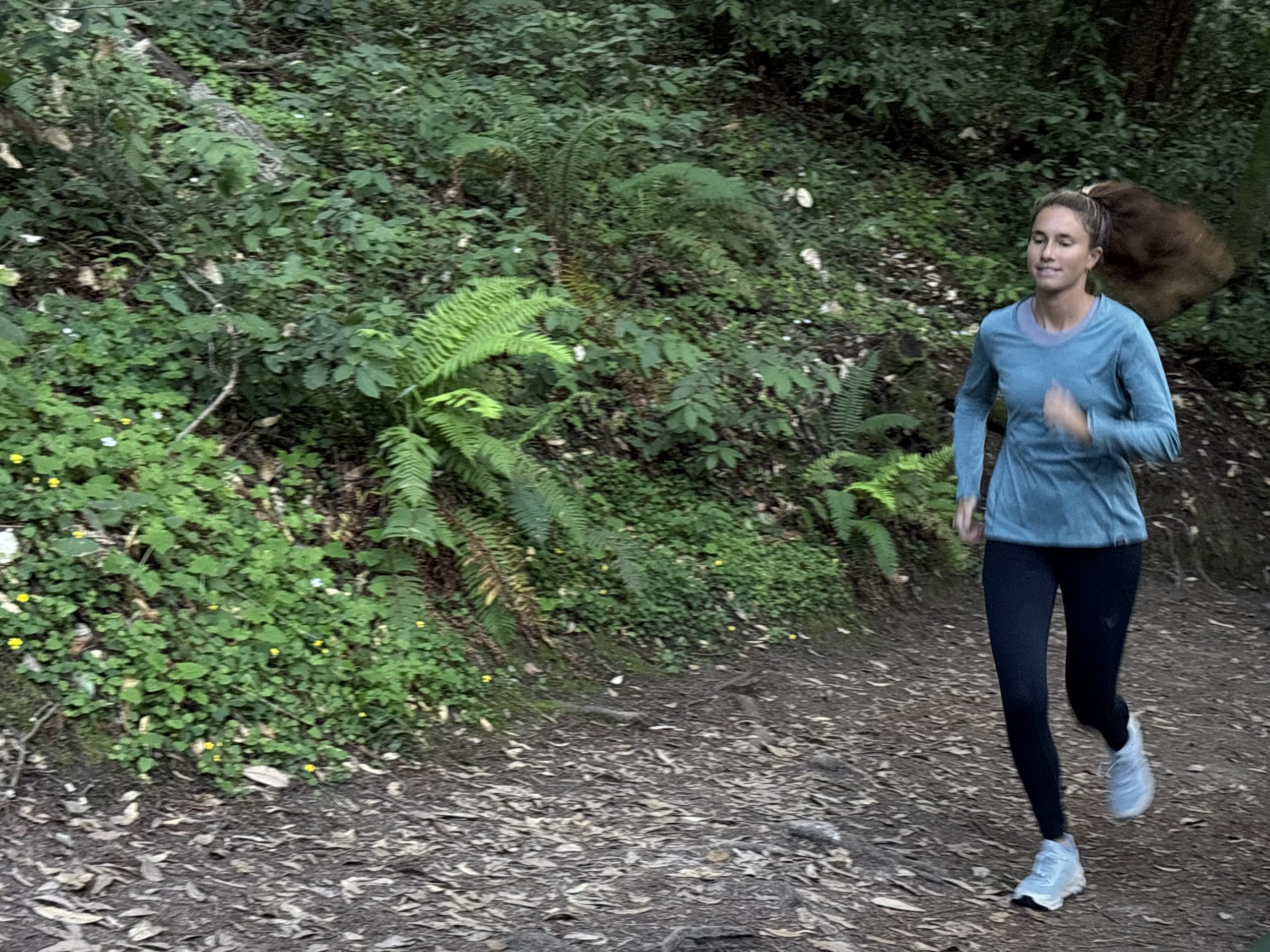 a woman running in the forest