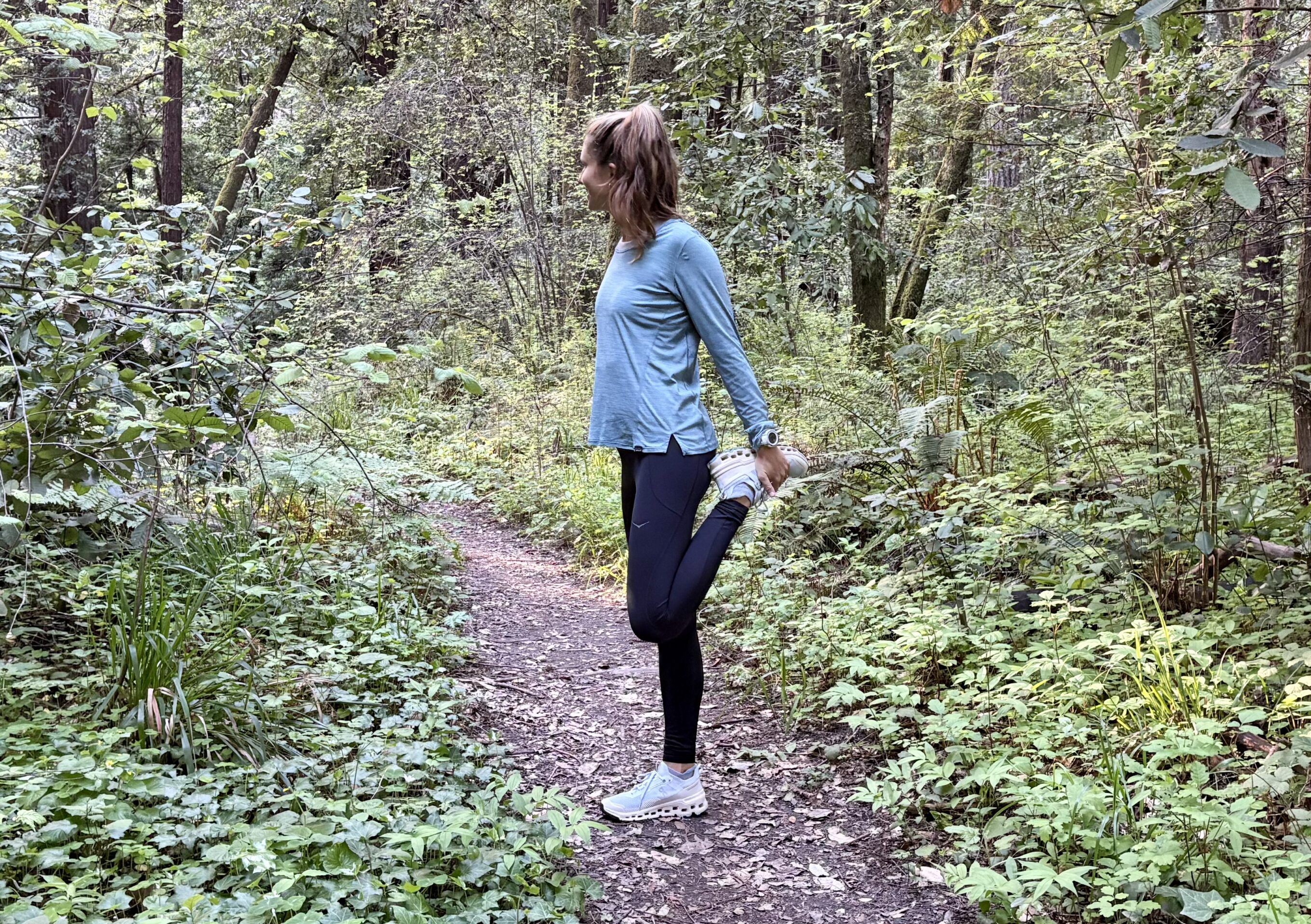 a woman stretching in the forest