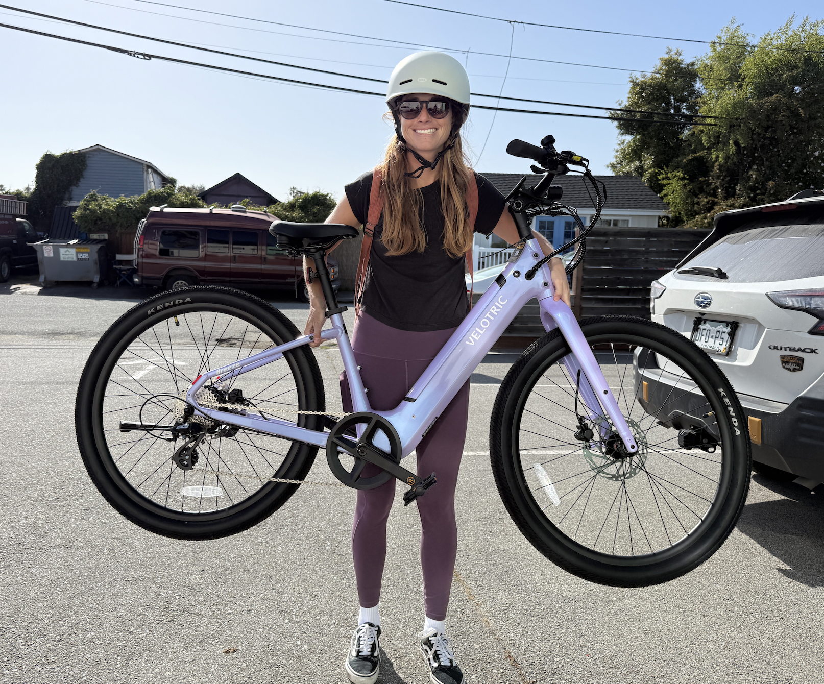 a woman holding an e-bike