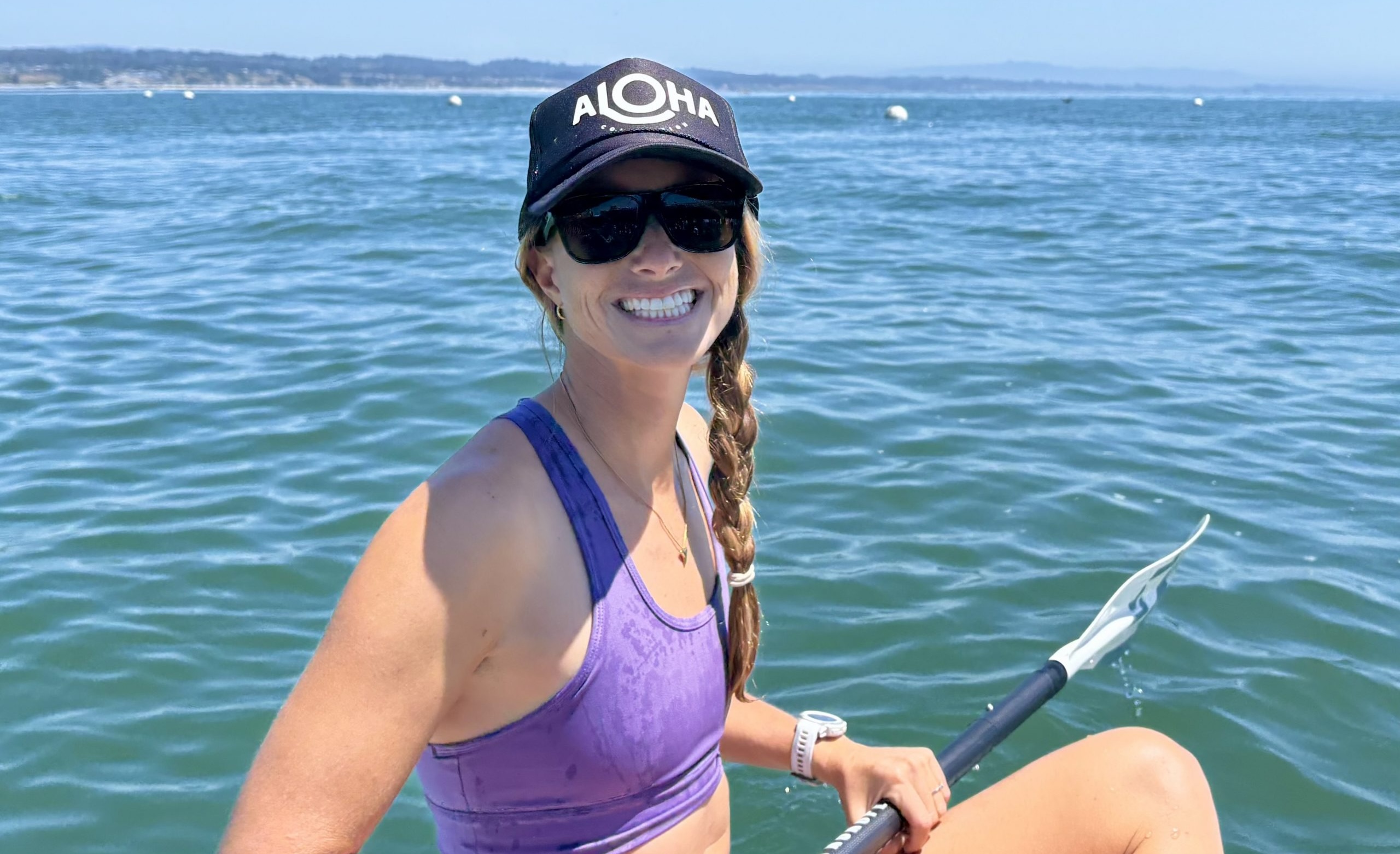Rebecca wearing sunglasses while paddle boarding