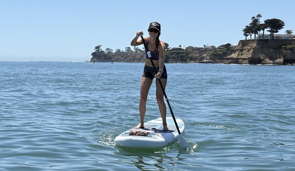 a woman stand up paddling on a Chasm-Lite