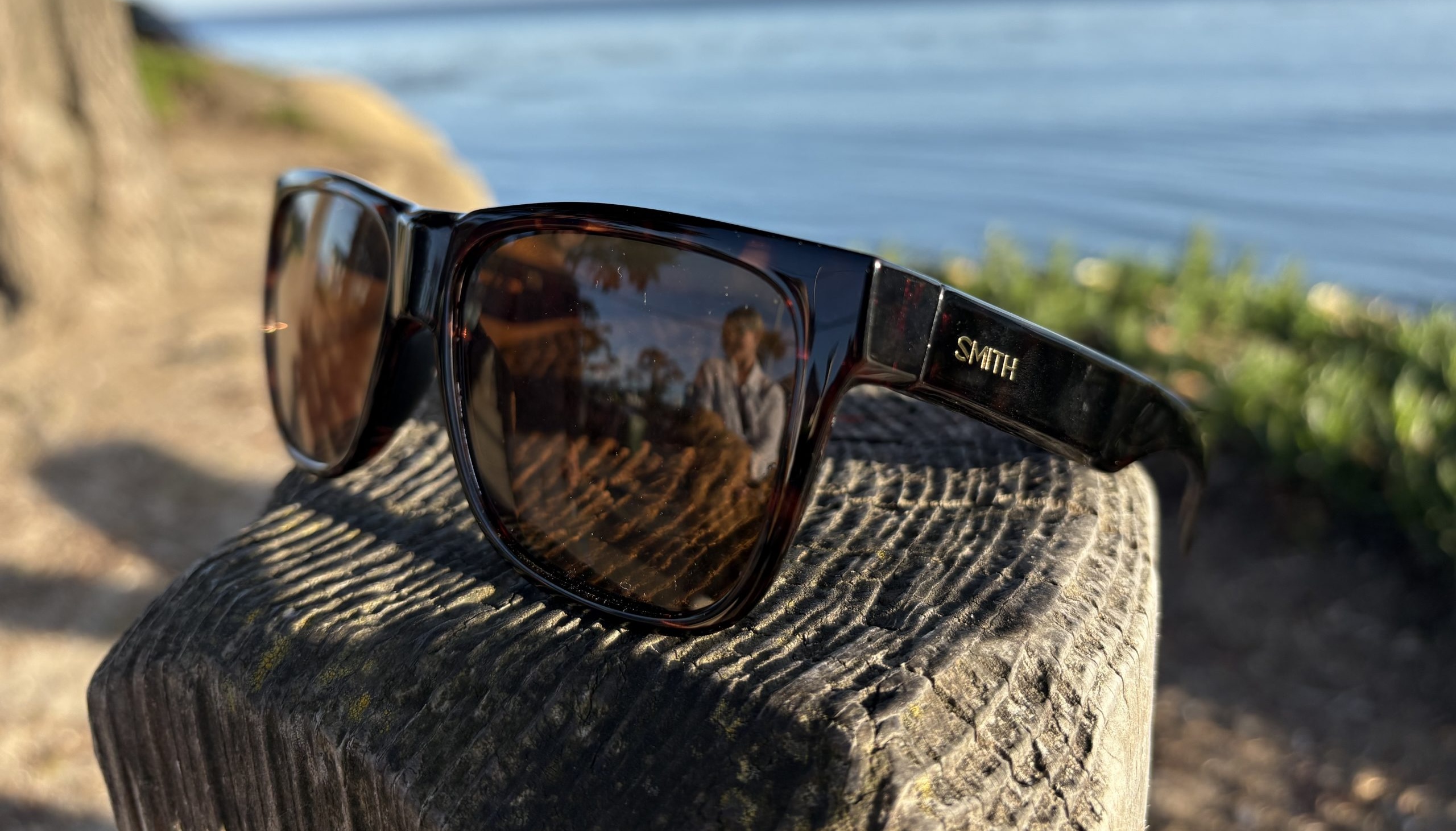 Smith Lowdown sunglasses on a fencepost by the water