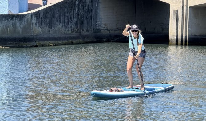 a woman paddling in a canal