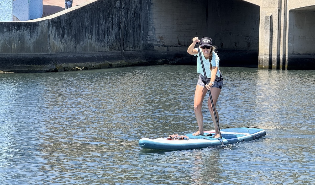 a woman paddling in a canal