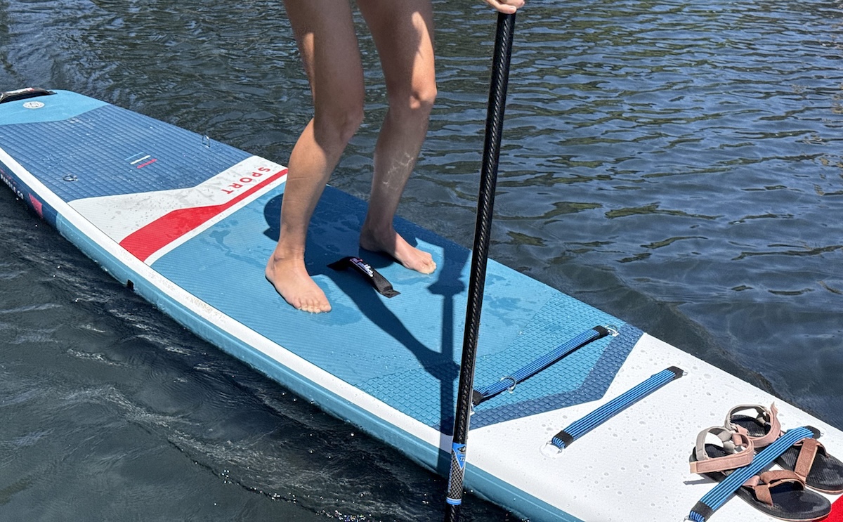 a woman paddling on the sport plus inflatable SUP