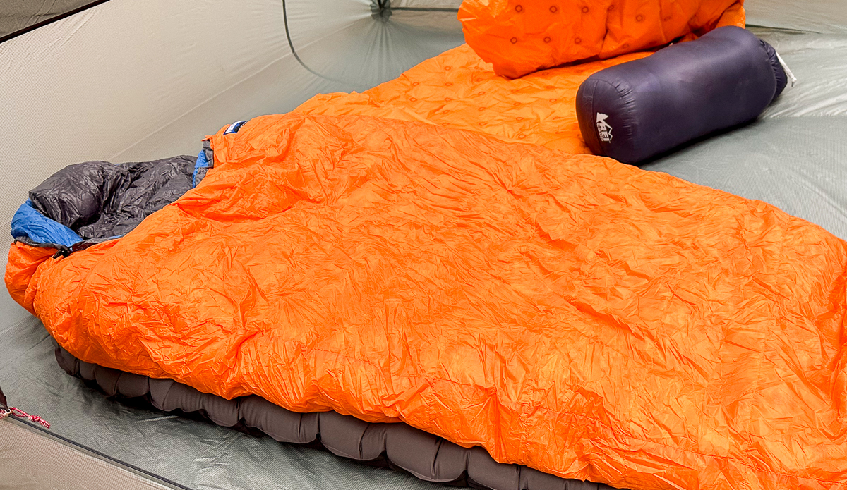 sleeping bag next to packed sleeping bag