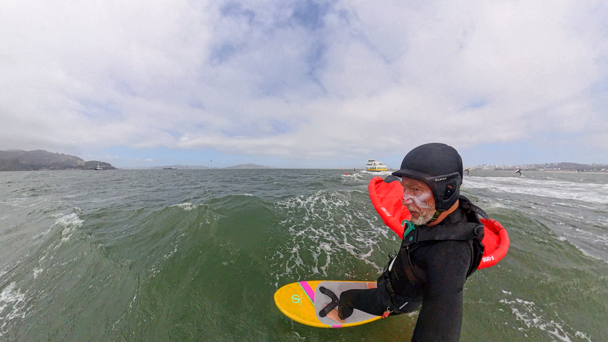 Bowen Dwelle carving on a ferry wake with the 4.2m F-One Plume flagged out