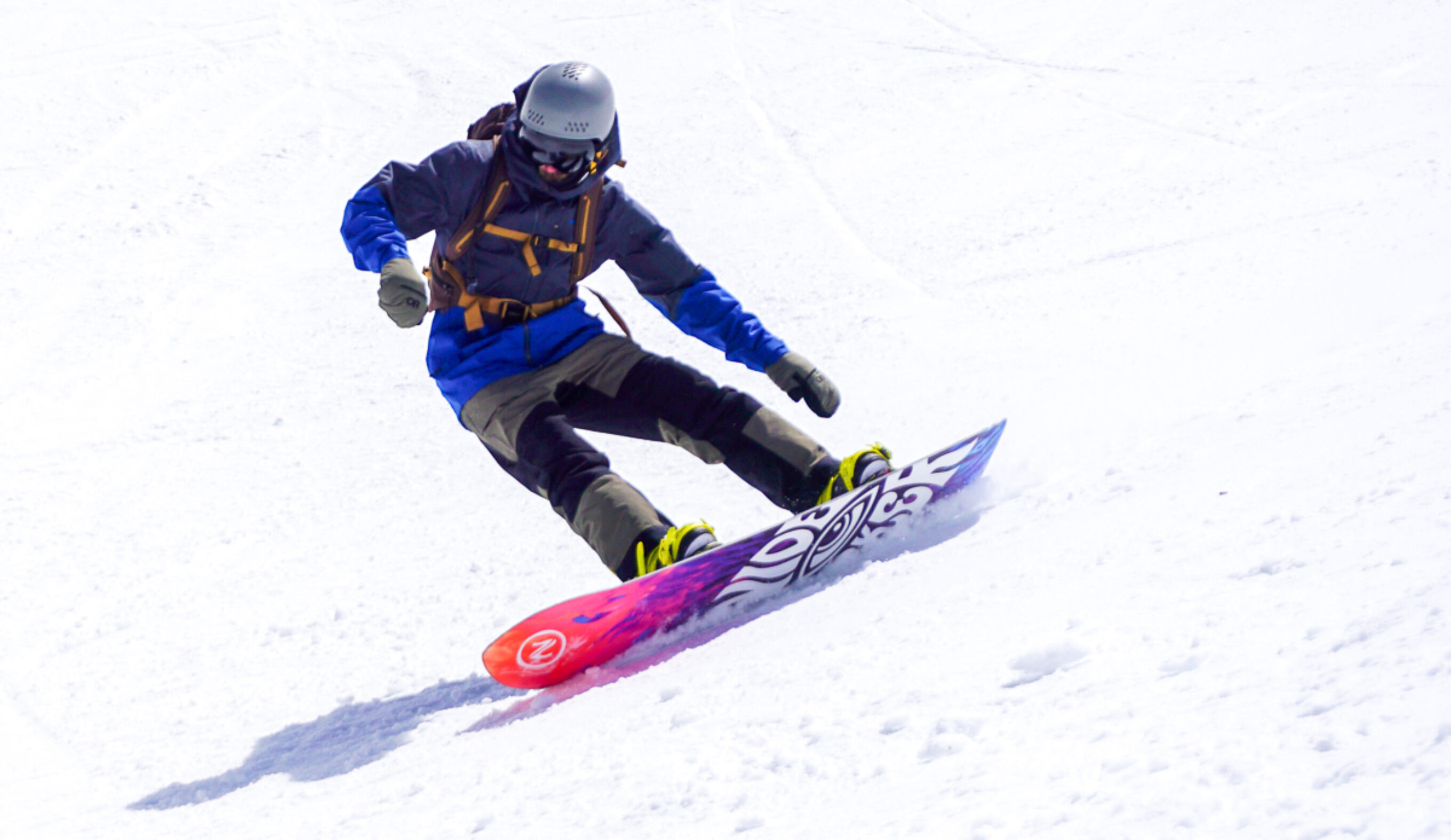 man carving on snowboard