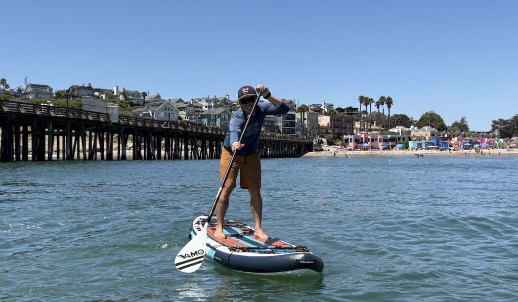 a man stand up paddling